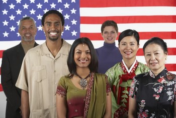 A group of resident aliens posing in front of an American flag.