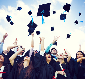 A group of graduates tossing their hats in the air.